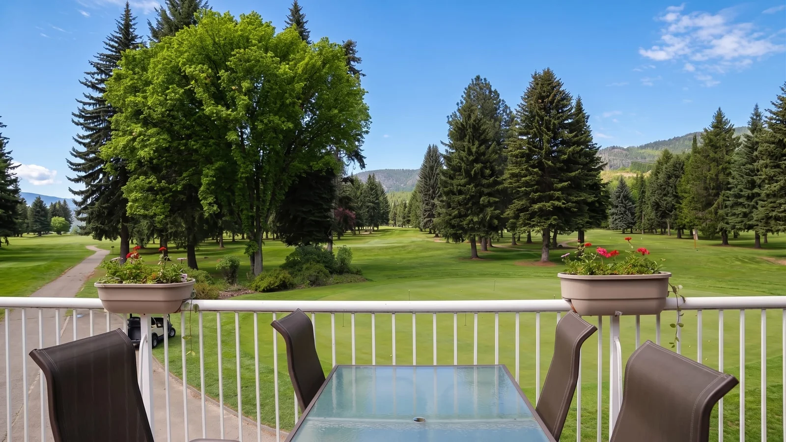 The covered Bistro patio at Birchbank, overlooking the first green with Monashee foothills beyond